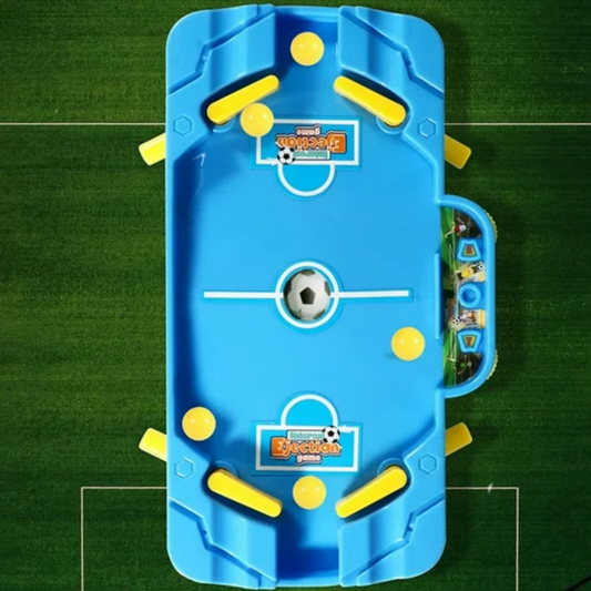 Blue and yellow toy foosball table on a green surface