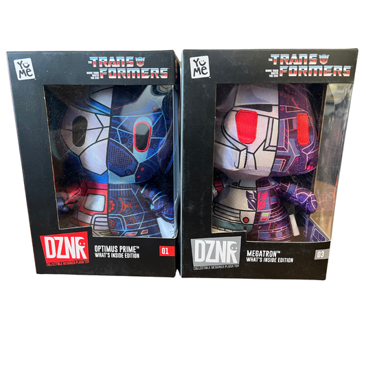Two Transformers figurine boxes, one with Optimus Prime and the other with Megatron, on a white background.