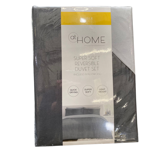 Packaged super soft reversible duvet set with 'at Home' branding on a white background