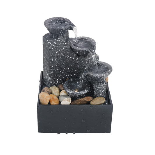 Decorative water fountain with speckled gray design on a white background